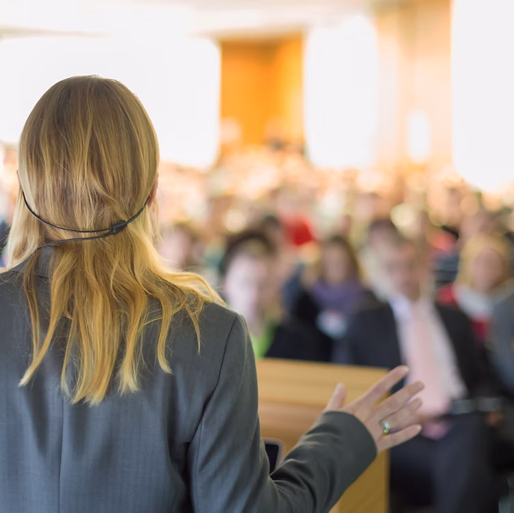 Woman presenting seminar to a crowd